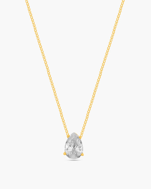 Gold necklace with a clear teardrop-shaped pendant on a white background